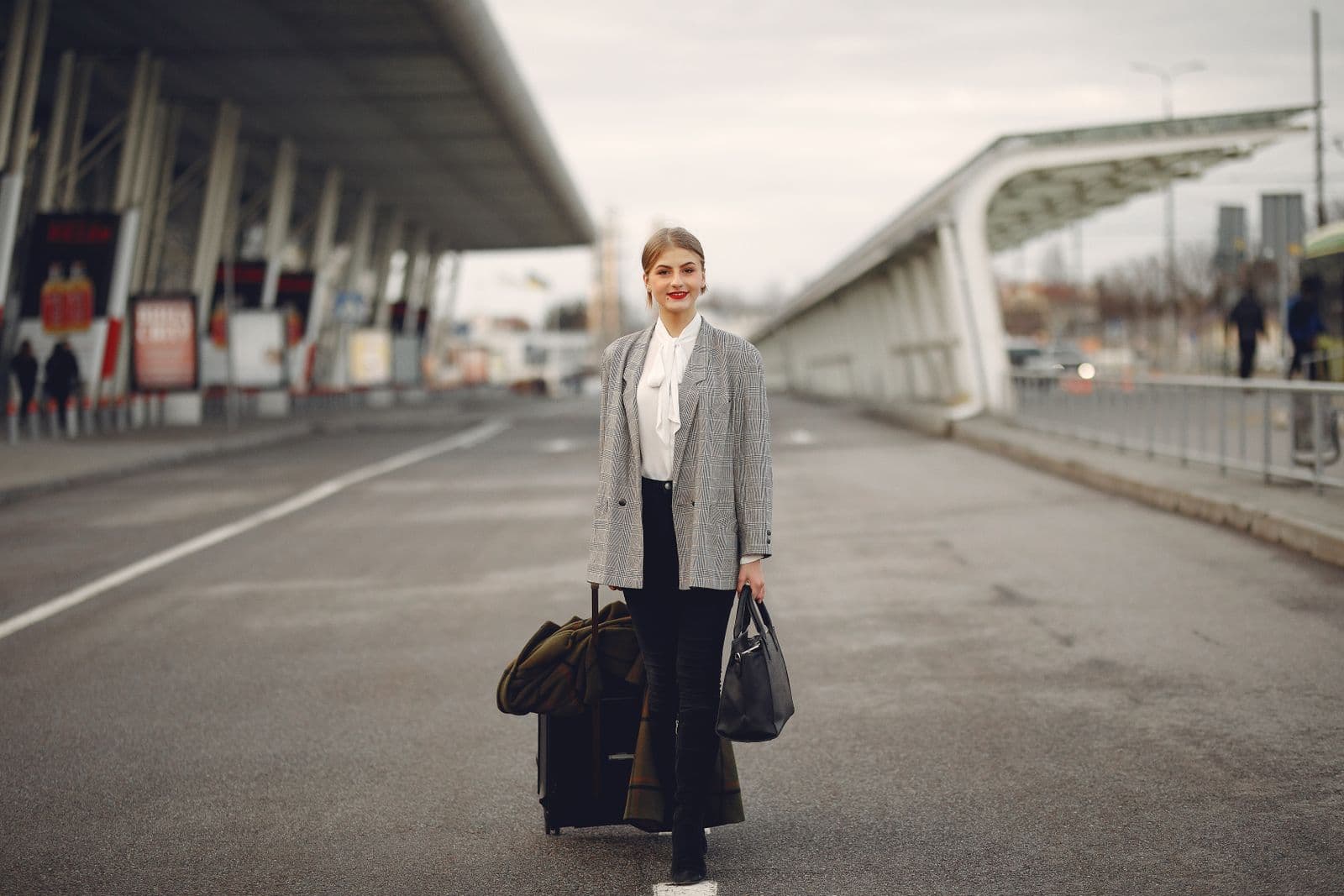 A traveller arriving with luggage at an urban terminal