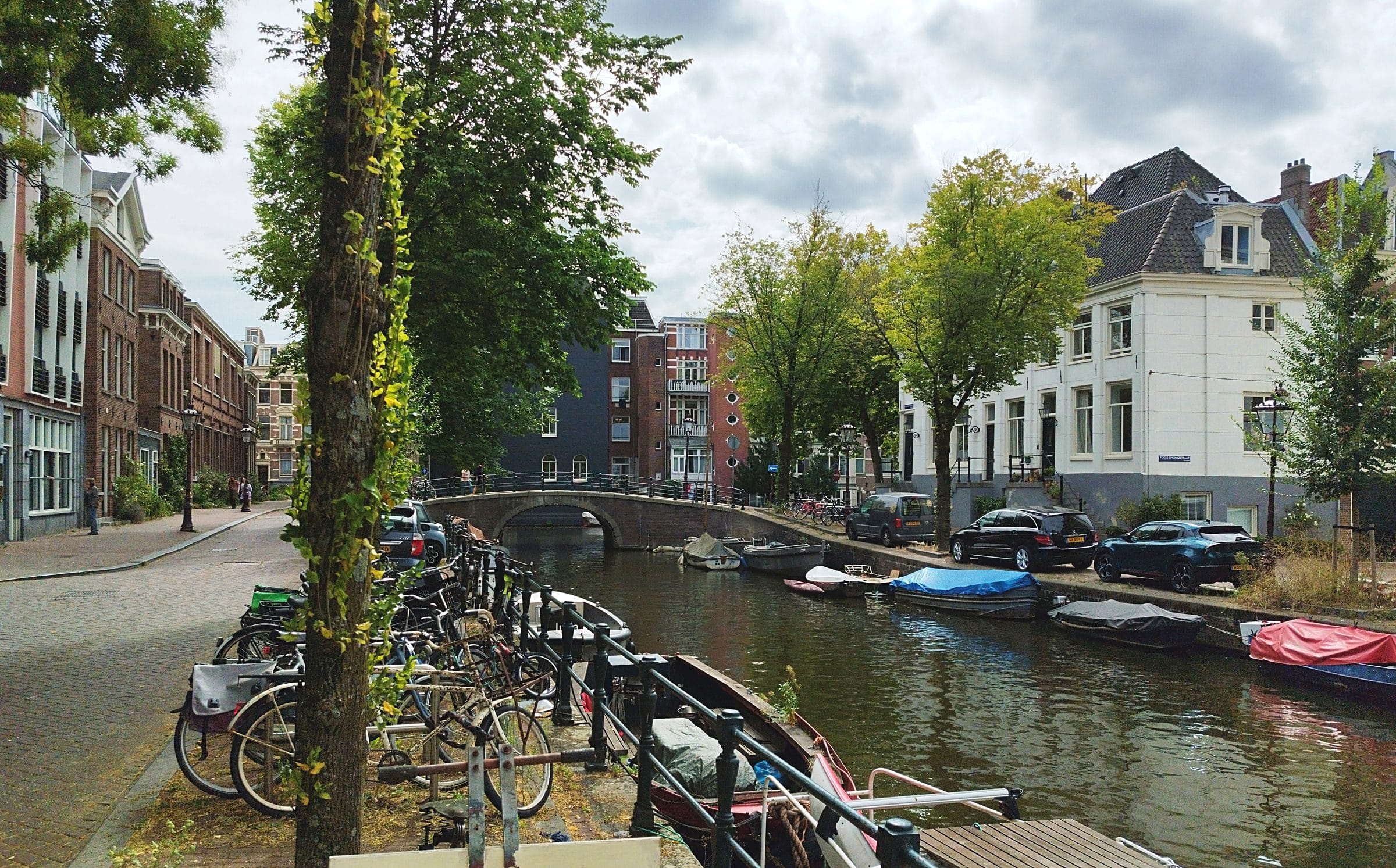 Canal with bicycles and boats in Amsterdam