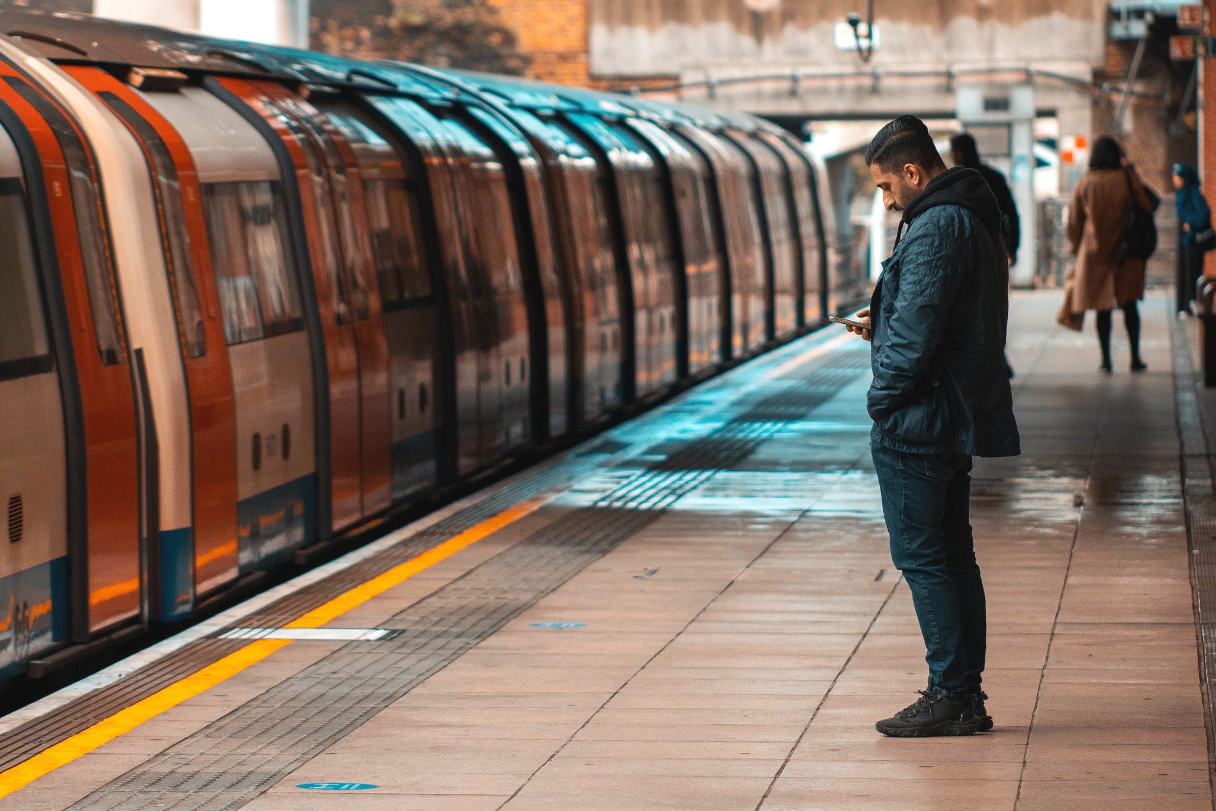 A man waiting on a station platform